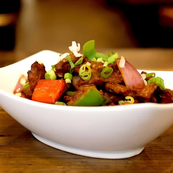 White Yak's chili beef, a Tibetan dish with red and green peppers, onions, and scallions.